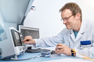 SMART TESTSOLUTIONS employee performs a measurement on an electronic assembly.